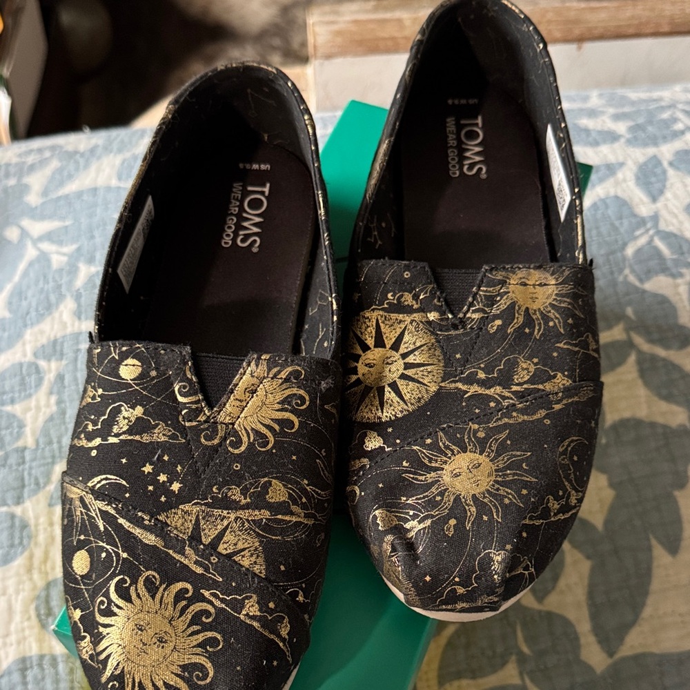 TOMS Celestial Black and Gold Slip-Ons
